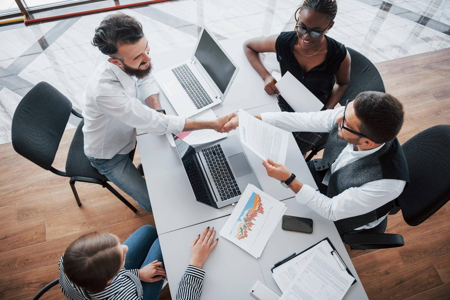 young-employees-sitting-office-table-using-laptop-team-work-brainstorming-meeting-concept (1)